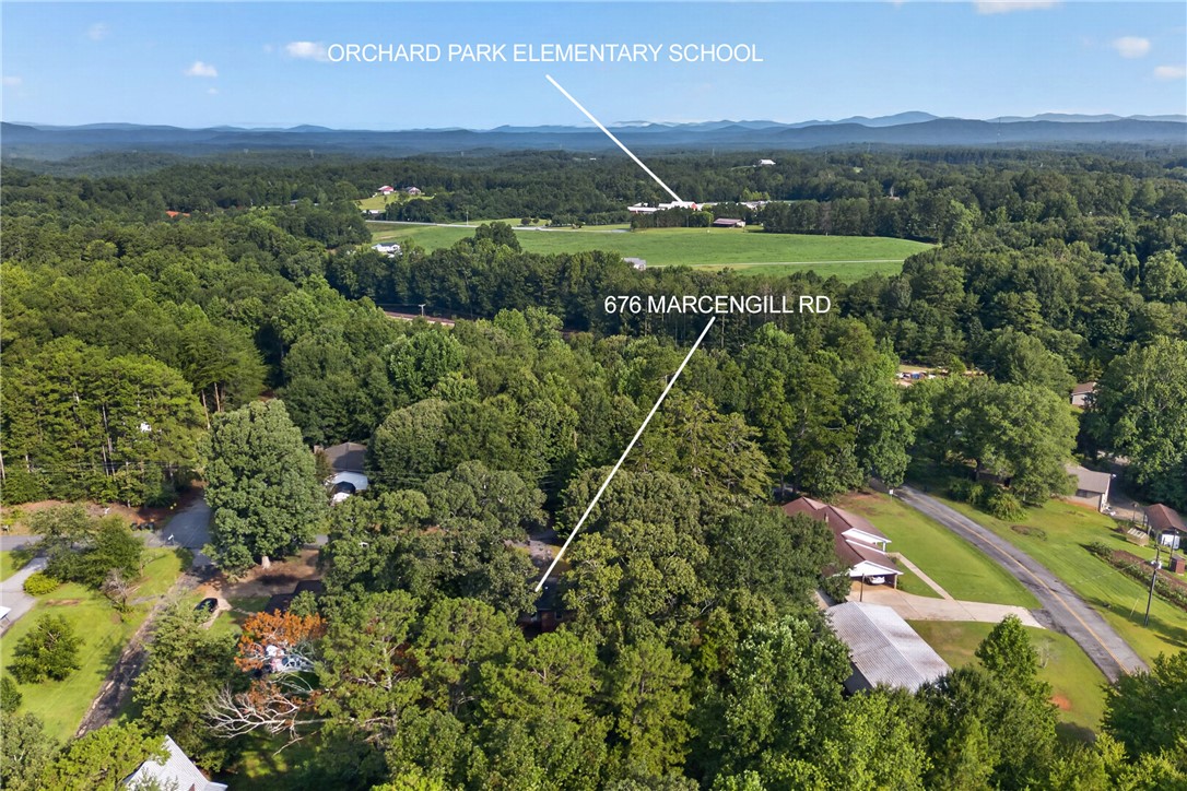 676 Marcengill Road Westminster, SC 29693 - Photo 31 of 32 Rolling hills and distant mountain peaks frame this beautiful wooded neighborhood.