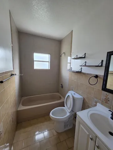 a bathroom with a sink a toilet and a bathtub