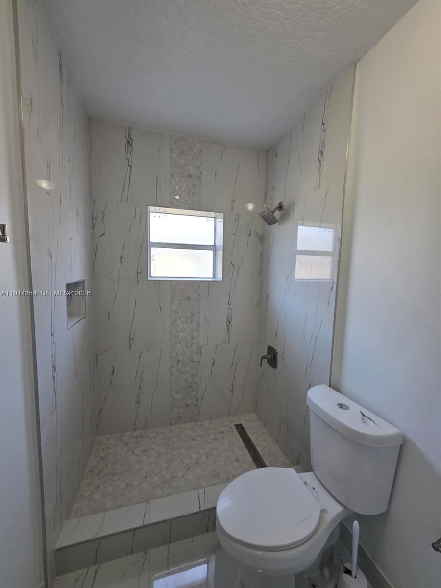 2970 Southwest 17th Street Miami, FL 33145 - Photo 14 of 27 a bathroom with a toilet and a shower