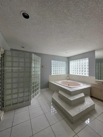 a spacious bathroom with a bathtub and window