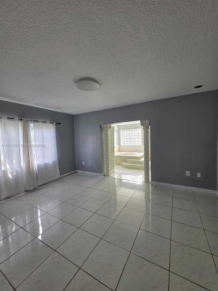 2970 Southwest 17th Street Miami, FL 33145 - Photo 20 of 27 a view of an empty room with window and chandelier fan