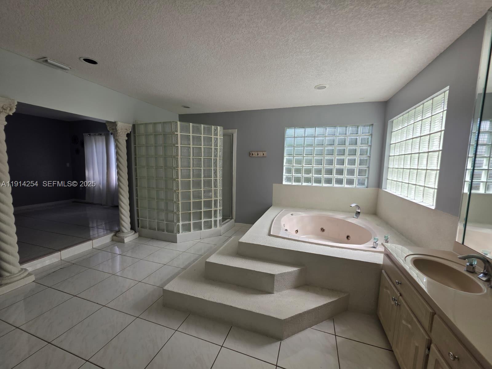 2970 Southwest 17th Street Miami, FL 33145 - Photo 21 of 25 a spacious bathroom with a tub sink and mirror