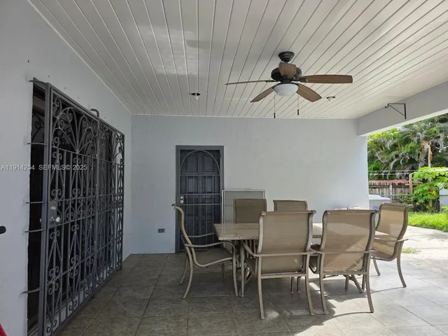 a dining room with furniture and a window
