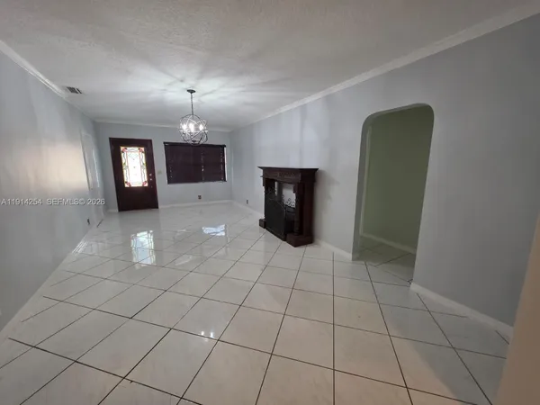 a dining room with furniture and a window