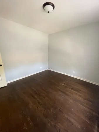 an empty room with wooden floor