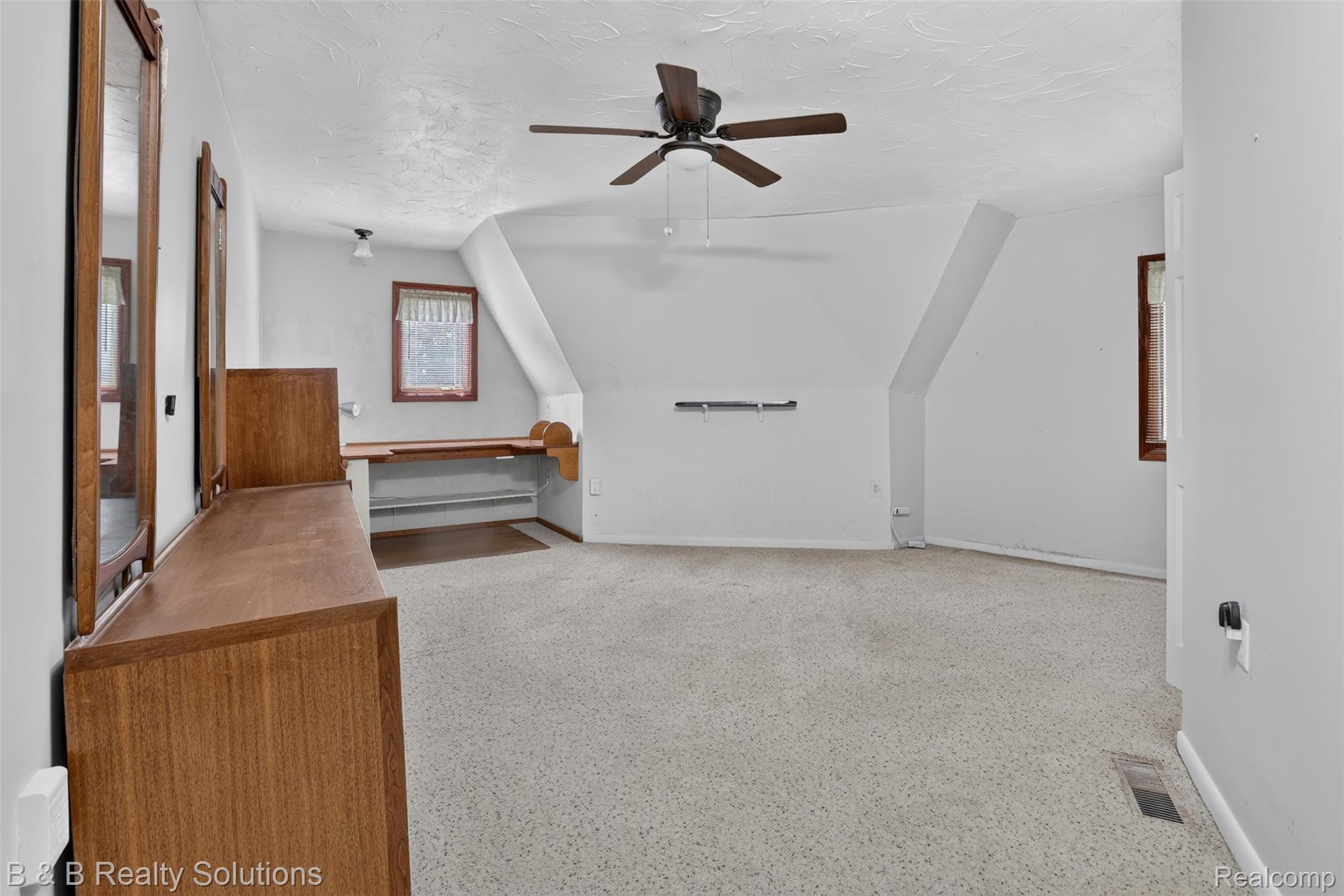 5544 Piersonville Road Columbiaville, MI 48421 - Photo 25 of 49 Spacious room featuring sloped ceilings, light-toned carpet, and a ceiling fan