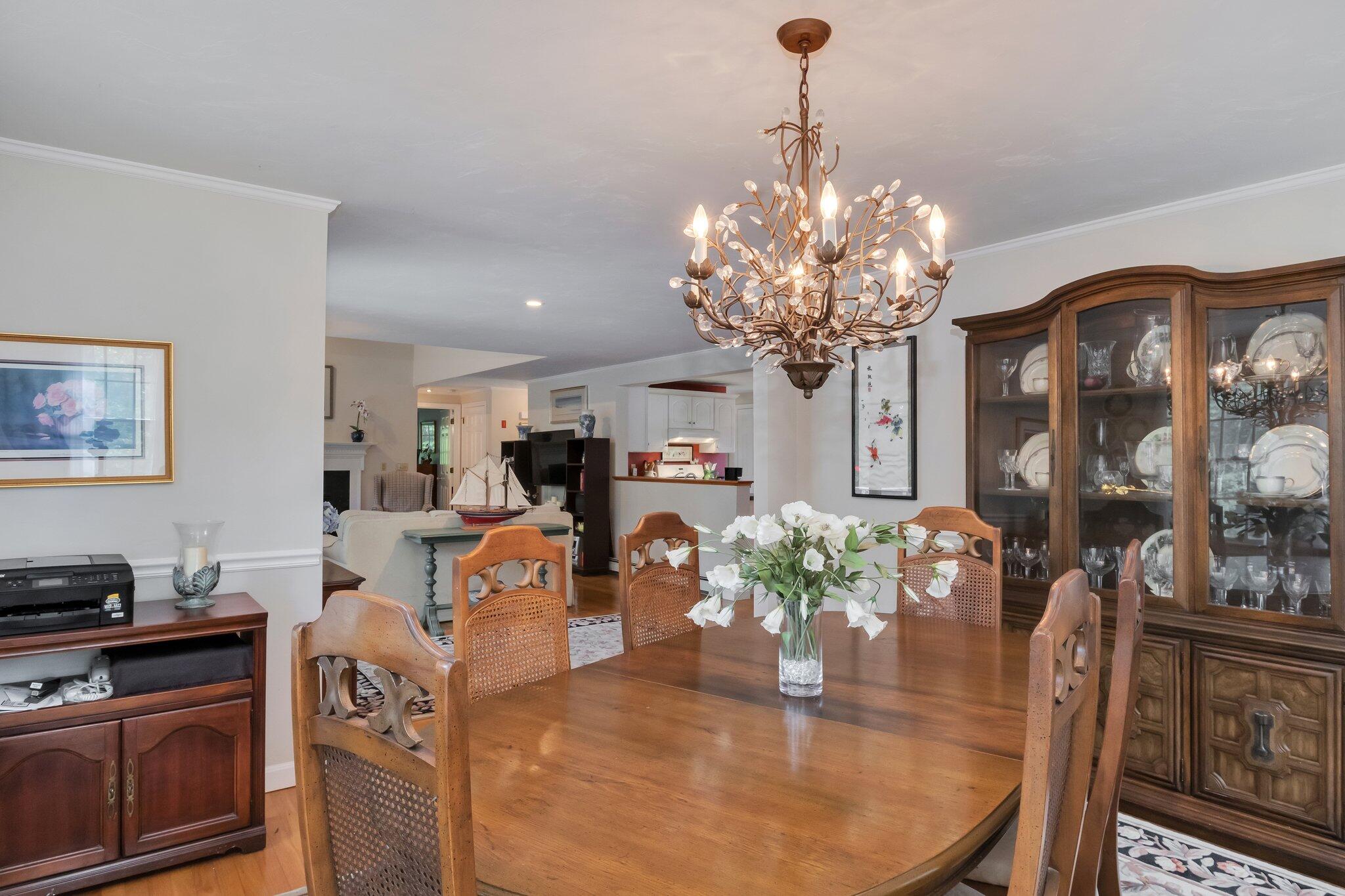 107 Clipper Way Brewster, MA 02631 - Photo 11 of 60 a living room with fireplace furniture and a chandelier