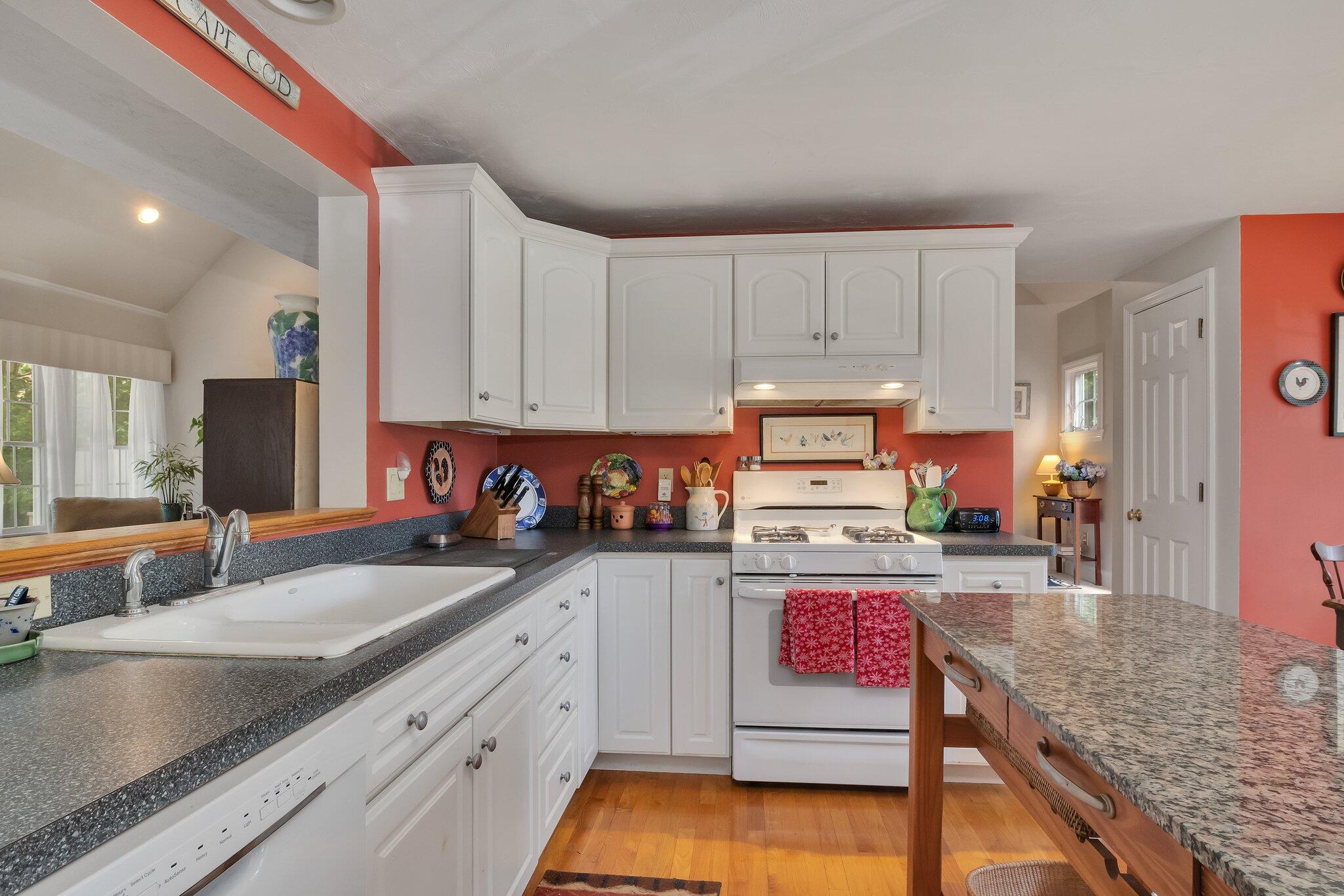 107 Clipper Way Brewster, MA 02631 - Photo 13 of 60 a kitchen with stainless steel appliances granite countertop a sink stove and cabinets