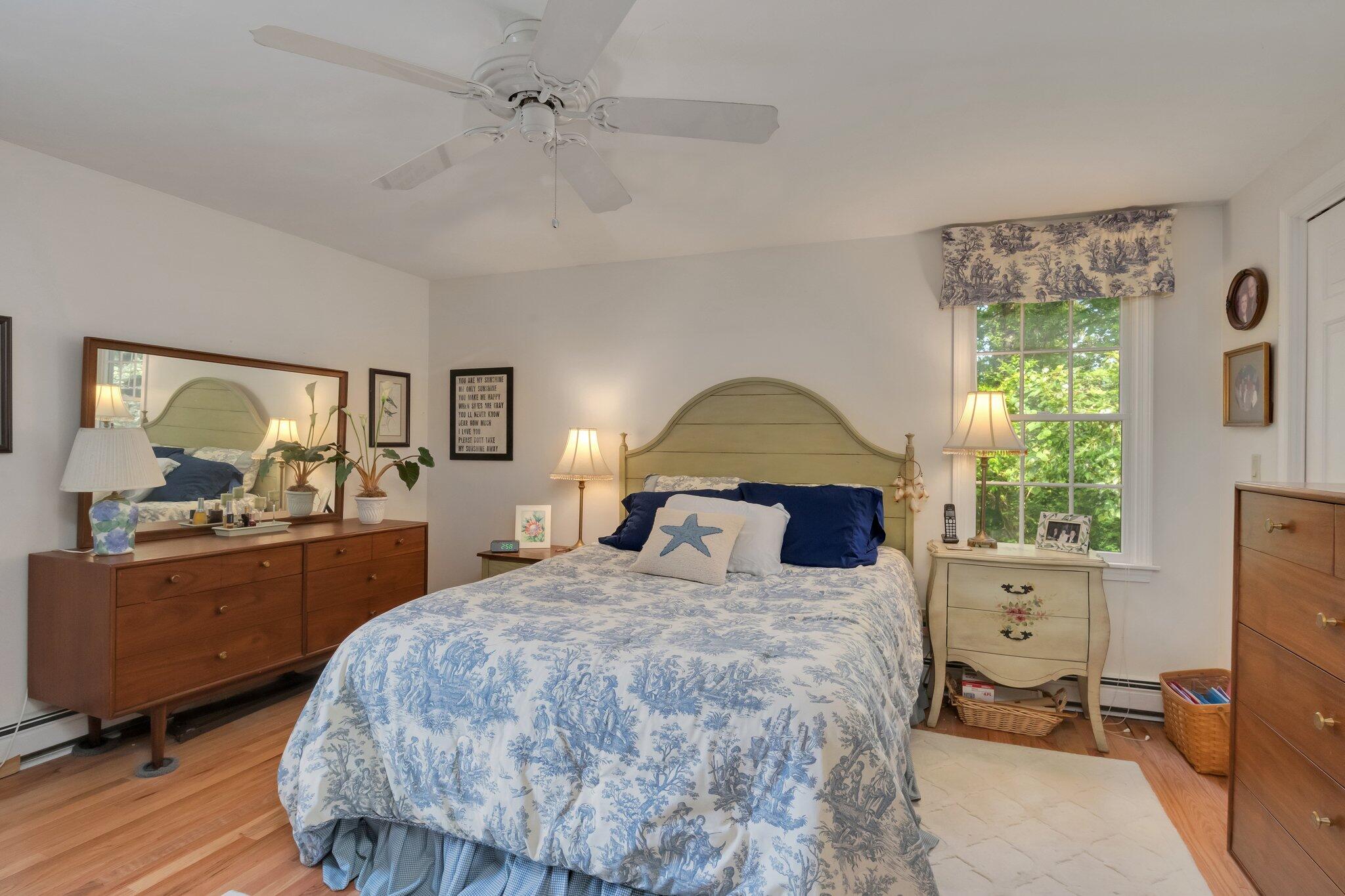 107 Clipper Way Brewster, MA 02631 - Photo 18 of 60 a bedroom with a large bed and a dresser