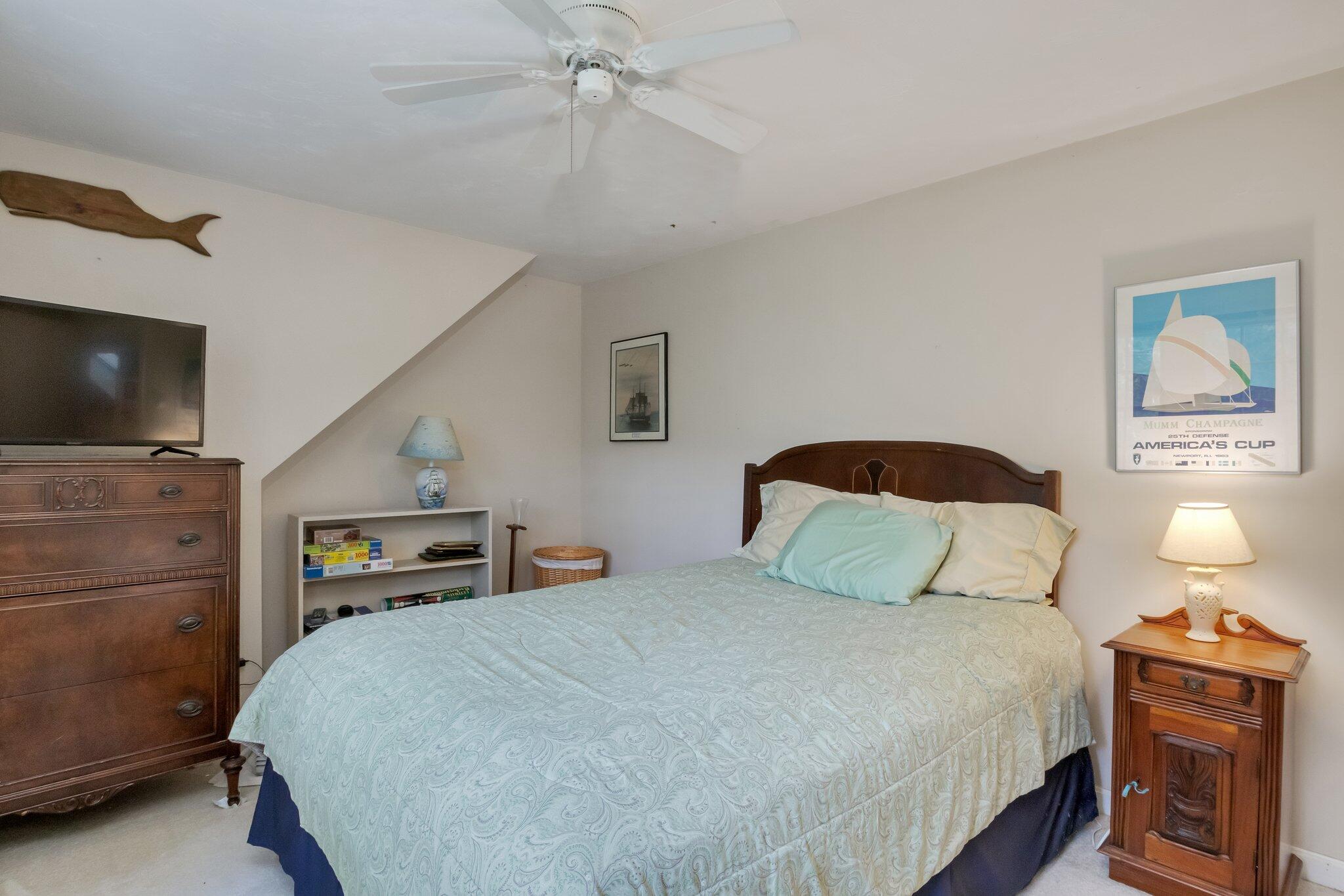 107 Clipper Way Brewster, MA 02631 - Photo 21 of 60 a bedroom with a bed and a tv