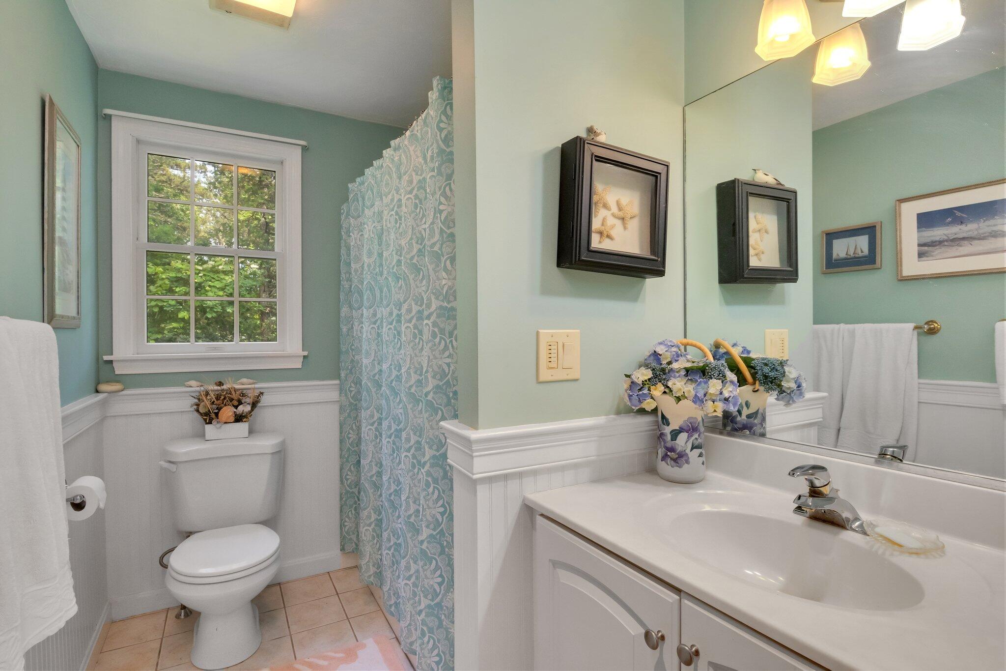107 Clipper Way Brewster, MA 02631 - Photo 23 of 60 a bathroom with a toilet sink and mirror