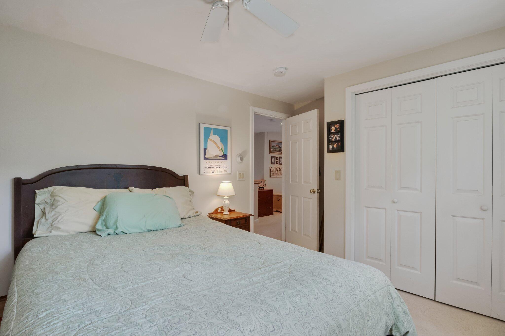 107 Clipper Way Brewster, MA 02631 - Photo 24 of 60 a bedroom with a bed and a night stand