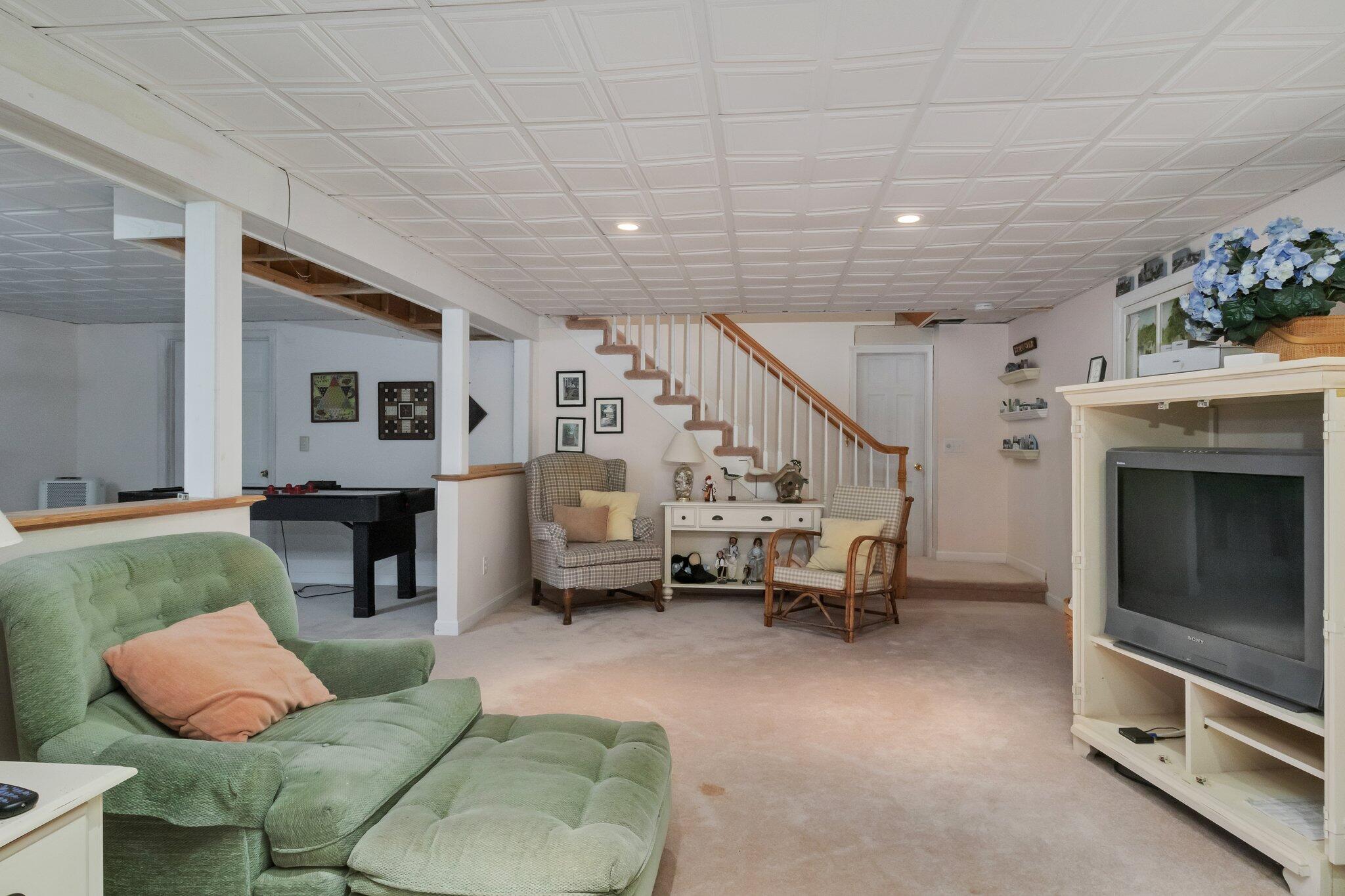 107 Clipper Way Brewster, MA 02631 - Photo 34 of 60 a living room with furniture and a fireplace