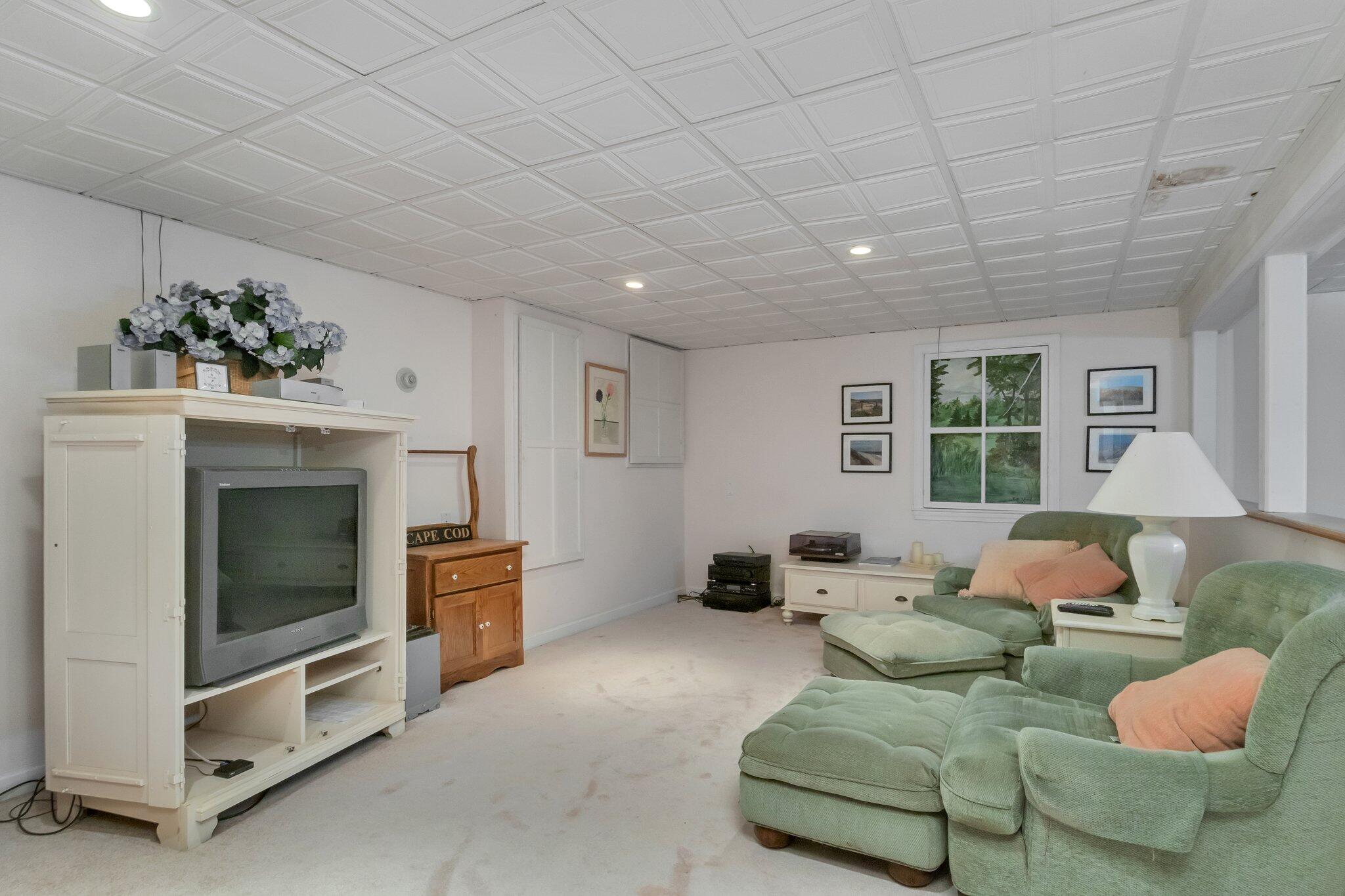 107 Clipper Way Brewster, MA 02631 - Photo 35 of 60 a living room with furniture and a fireplace