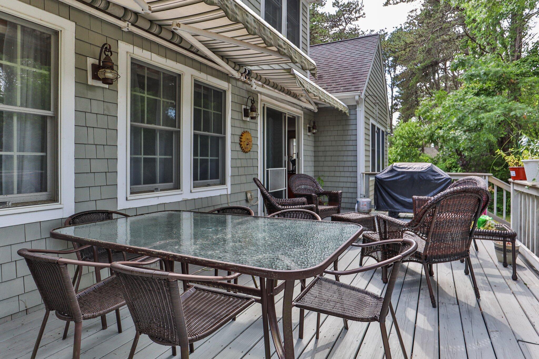 107 Clipper Way Brewster, MA 02631 - Photo 41 of 60 a backyard of a house with table and chairs