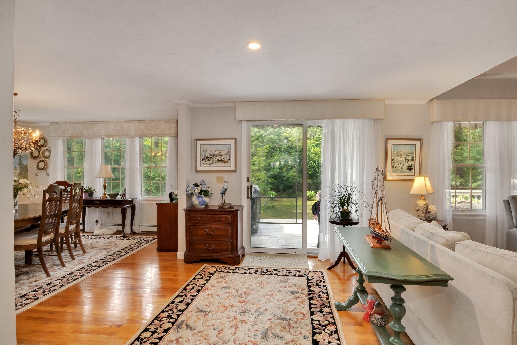 107 Clipper Way Brewster, MA 02631 - Photo 5 of 60 a living room with furniture a large window and wooden floor