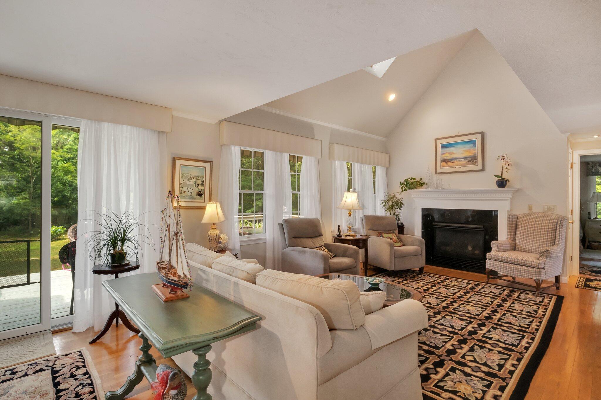 107 Clipper Way Brewster, MA 02631 - Photo 6 of 60 a living room with furniture and a fireplace