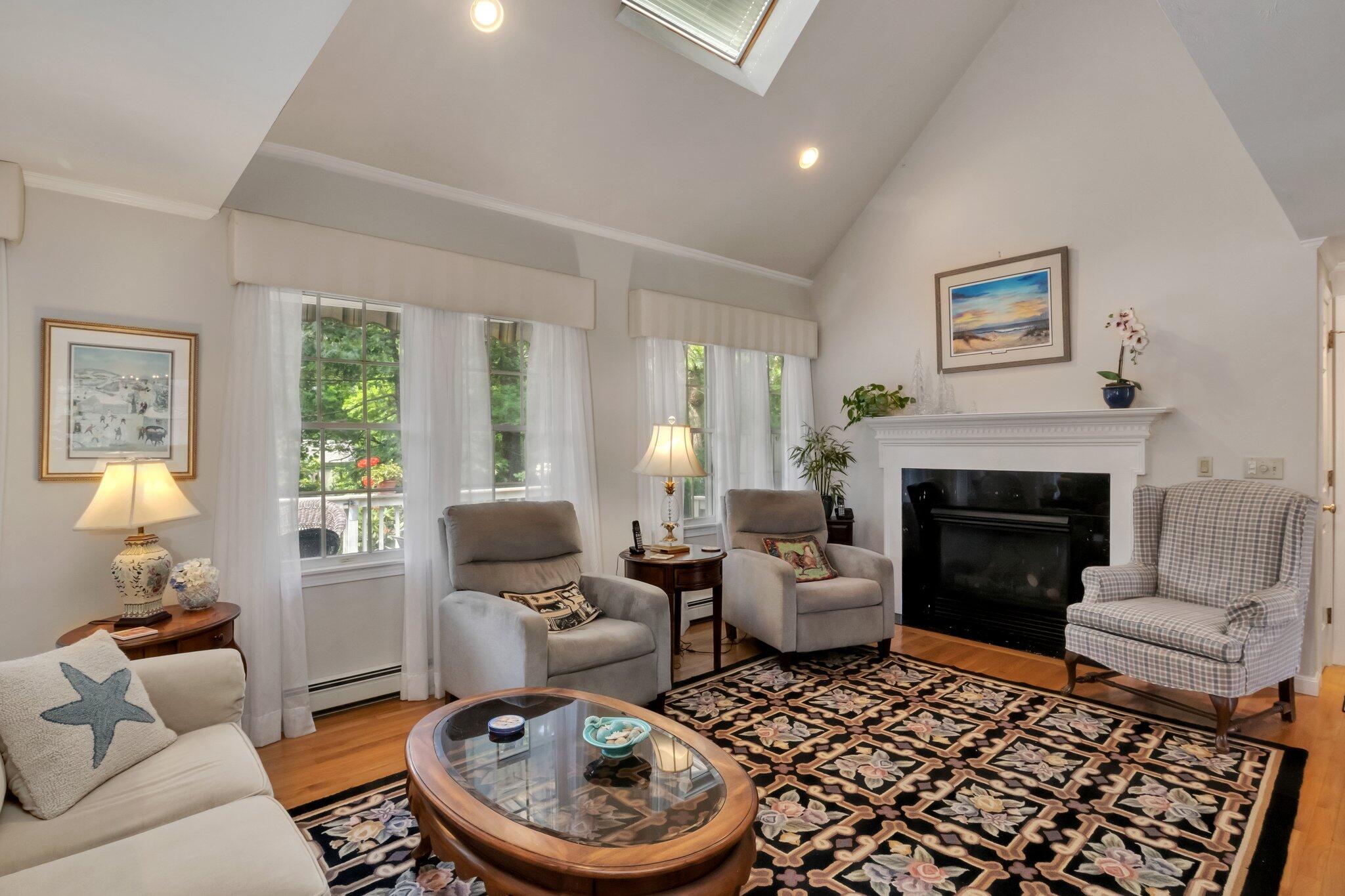 107 Clipper Way Brewster, MA 02631 - Photo 7 of 60 a living room with furniture and a fireplace