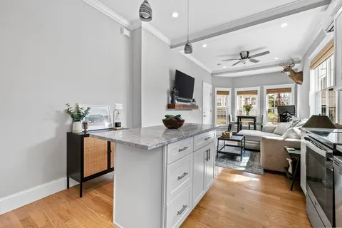 a large white kitchen with a large window