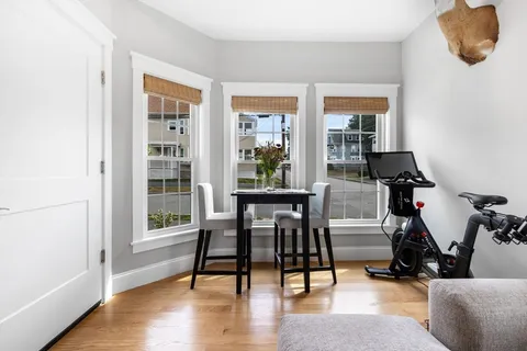 a workspace with furniture hardwood and a window