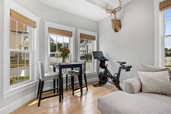 a view of a livingroom and dining room with wooden floor windows