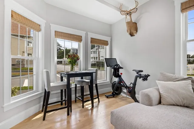 a view of a livingroom and dining room with wooden floor windows