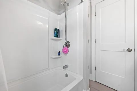 a bathroom with a bathtub and a shower