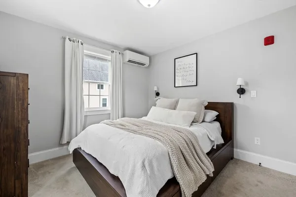a bedroom with a bed and window