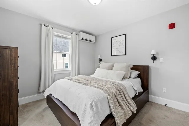 a bedroom with a bed and window