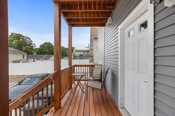 a view of balcony with wooden floor and fence