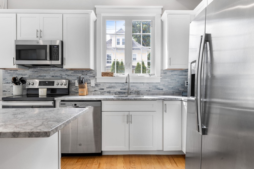 127 Marblehead Street, Unit A North Andover, MA 01845 - Photo 6 of 30 a kitchen with stainless steel appliances granite countertop a sink and a refrigerator
