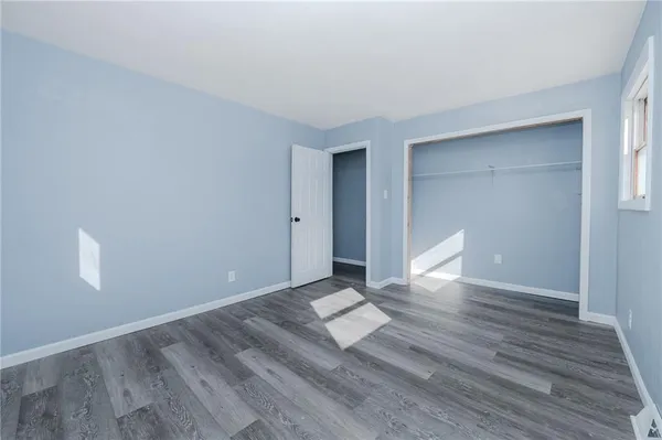 a view of wooden floor and windows in a room