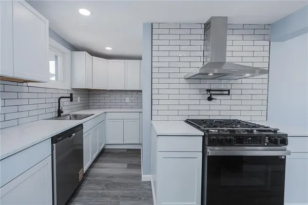 a kitchen with cabinets and appliances