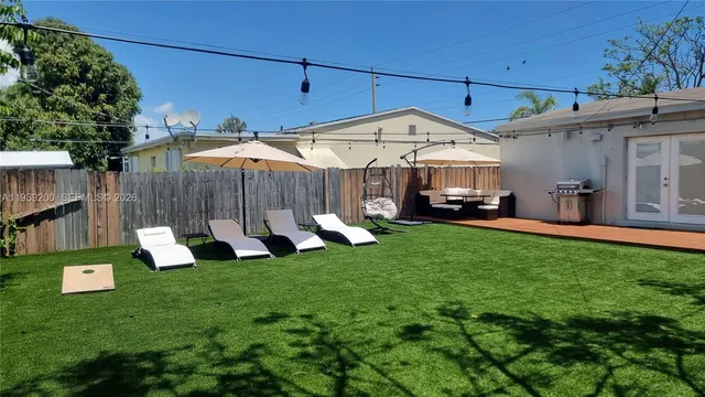 a front view of a house with garden and sitting area