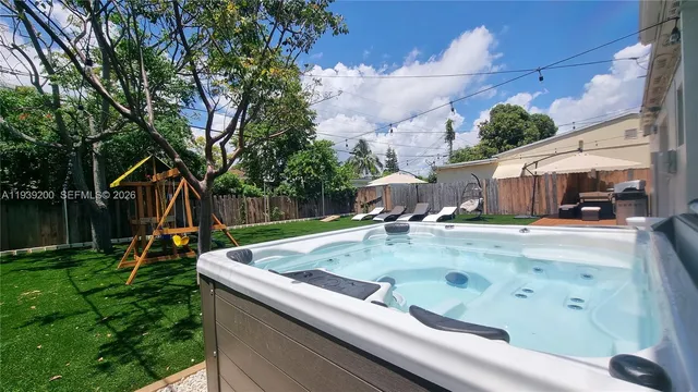 a view of a backyard with swimming pool