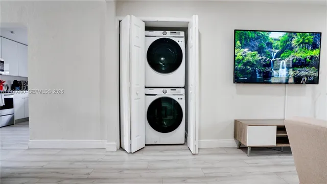 a view of a hallway with washer and dryer