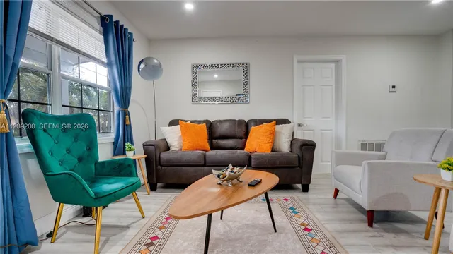 a living room with furniture and a potted plant