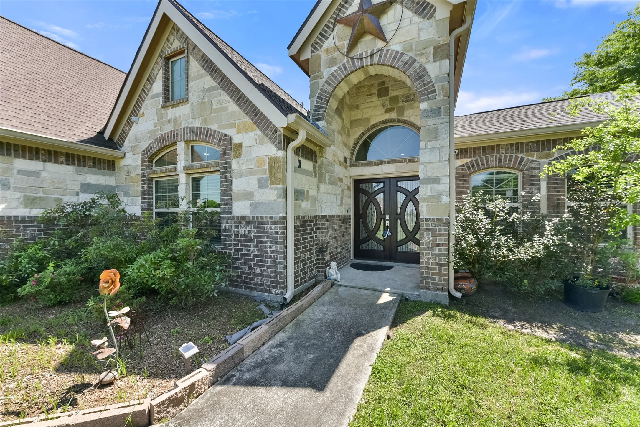 30805 Coco Street Cypress, TX 77433 - Photo 2 of 38 a front view of a house with a garden