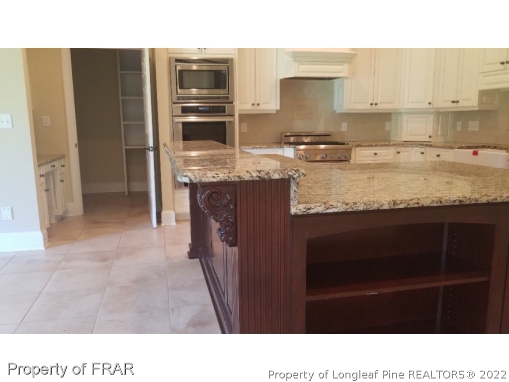 525 Rob Road Stedman, NC 28391 - Photo 13 of 23 a kitchen with granite countertop a sink cabinets and stainless steel appliances