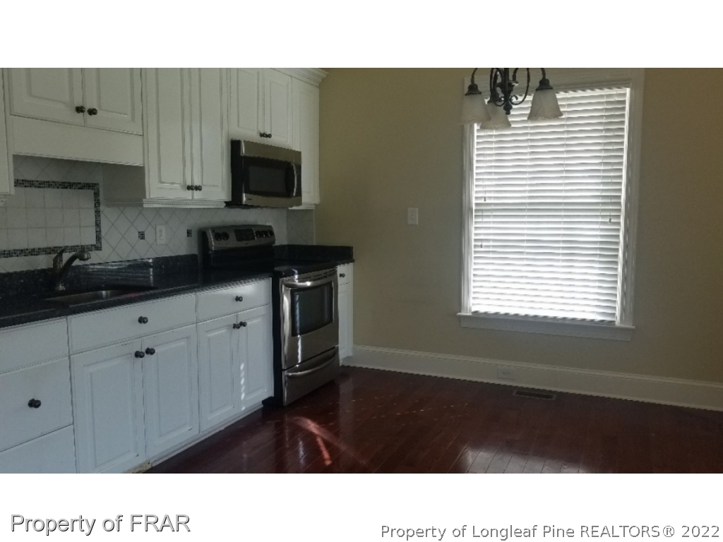 525 Rob Road Stedman, NC 28391 - Photo 20 of 23 a kitchen with a sink a microwave and cabinets