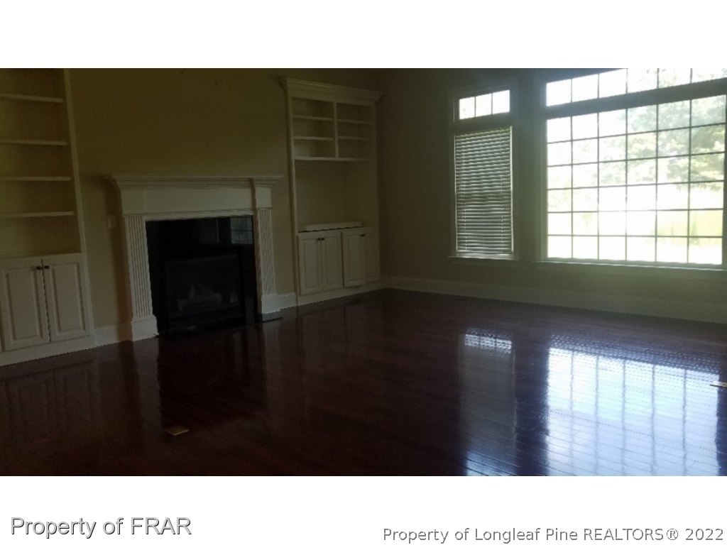 525 Rob Road Stedman, NC 28391 - Photo 5 of 23 a open hall with a floor to ceiling window and wooden floor