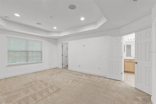 an empty room with a empty space and windows