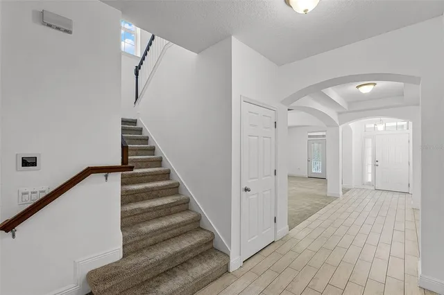 a view of a hallway with wooden floor and entryway