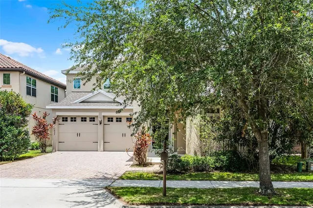 a front view of a house with a yard and a garage
