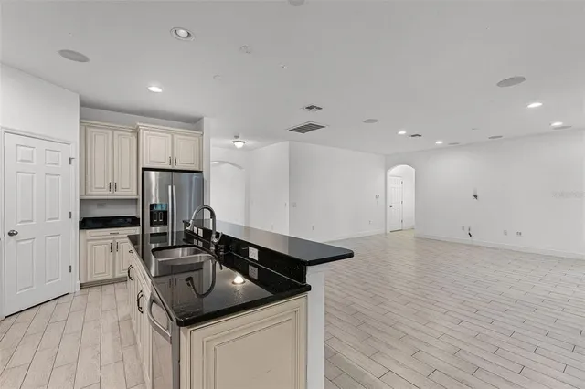 a kitchen that has a sink and a stove in it