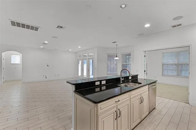 a kitchen with granite countertop a sink and cabinets