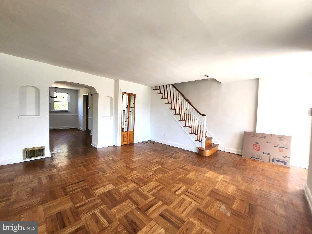 443 Pleasant Street Philadelphia, PA 19119 - Photo 3 of 13 a view of an empty room with stairs and a window