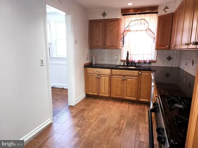 a kitchen with wooden floors and a window