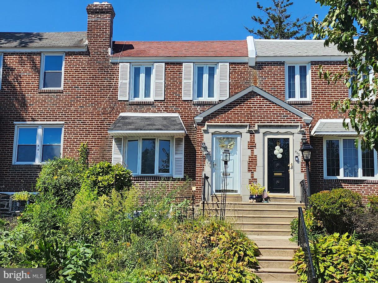 443 Pleasant Street Philadelphia, PA 19119 - Photo 5 of 13 front view of a brick house with a small yard