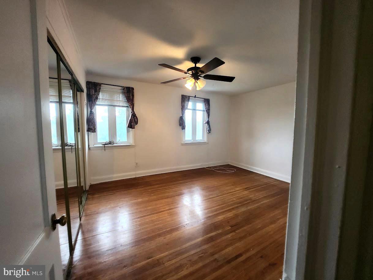 443 Pleasant Street Philadelphia, PA 19119 - Photo 7 of 13 an empty room with wooden floor and windows